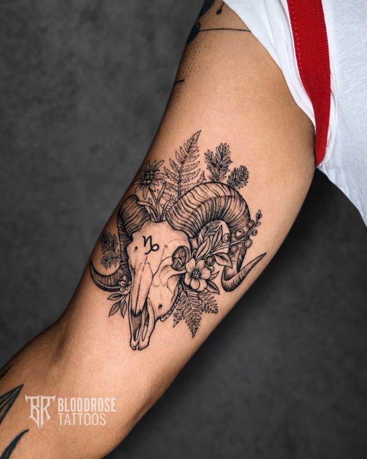 Ram skull and botanical tattoo