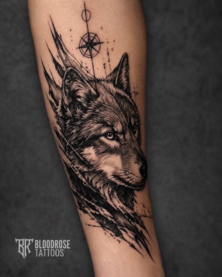 Custom wolf tattoo with compass, black and grey