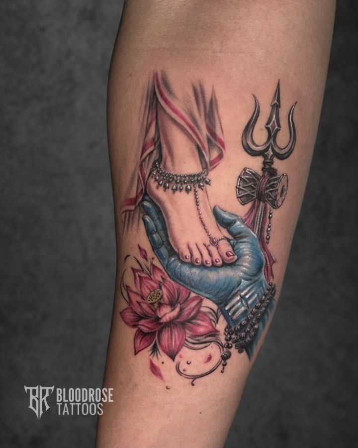 Shiva Shakti tattoo with trishul and lotus